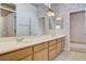 Bathroom with a double vanity, tile floor, and wallpaper at 931 Temple View Dr, Las Vegas, NV 89110