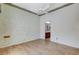 Bedroom with ceiling fan, wood floors, and view into the adjacent bathroom at 931 Temple View Dr, Las Vegas, NV 89110