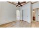 Cozy bedroom offers wood-look floors, a ceiling fan, and easy access to the bathroom at 931 Temple View Dr, Las Vegas, NV 89110