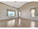 Spacious bedroom features natural light from large windows, complemented by wood-look flooring at 931 Temple View Dr, Las Vegas, NV 89110