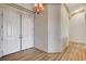 Spacious foyer with double doors, wood-look flooring, and textured wallpaper at 931 Temple View Dr, Las Vegas, NV 89110