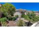 Charming front entrance with desert landscaping, plants and trees at 931 Temple View Dr, Las Vegas, NV 89110