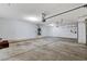 This spacious garage features high ceilings, concrete floors, and ample room for storage or vehicles at 931 Temple View Dr, Las Vegas, NV 89110