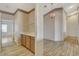 This hallway features wood floors, a chandelier, and a sink area, seamlessly connecting various spaces at 931 Temple View Dr, Las Vegas, NV 89110