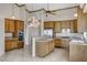 Bright kitchen features tile flooring, stainless steel appliances, wooden cabinets, and a breakfast bar at 931 Temple View Dr, Las Vegas, NV 89110