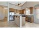 Bright kitchen features tile flooring, stainless steel appliances, wooden cabinets, and a breakfast bar at 931 Temple View Dr, Las Vegas, NV 89110