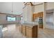 Open concept kitchen with granite countertops, tile flooring, stainless oven, and breakfast bar at 931 Temple View Dr, Las Vegas, NV 89110