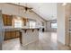 Open concept kitchen with granite countertops, tile flooring, stainless appliances, and breakfast bar at 931 Temple View Dr, Las Vegas, NV 89110