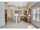 Bright kitchen features tile flooring, stainless steel appliances, wooden cabinets, and a breakfast bar at 931 Temple View Dr, Las Vegas, NV 89110