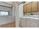 The laundry room offers mountain views, wood floors, cabinets, and side-by-side washer and dryer units at 931 Temple View Dr, Las Vegas, NV 89110