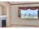 Bright living room features a large window showcasing stunning city views and a cozy fireplace at 931 Temple View Dr, Las Vegas, NV 89110