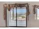 Charming patio view featuring a sliding glass door with curtains and a water fountain at 931 Temple View Dr, Las Vegas, NV 89110
