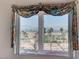 Scenic window view of a landscaped yard, water fountain, and distant city skyline at 931 Temple View Dr, Las Vegas, NV 89110