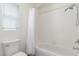 Clean bathroom with white tiles, bathtub, shower and toilet is brightly illuminated by the natural light at 9339 Bondeno St, Las Vegas, NV 89123