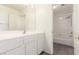 Bathroom with white cabinetry, double vanity sinks, and access to a tub and shower at 9339 Bondeno St, Las Vegas, NV 89123