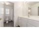 Bathroom features a toilet, shower, sink, vanity, and a well-lit mirror for grooming at 9339 Bondeno St, Las Vegas, NV 89123