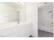 Bathroom with a wide mirror over the vanity and a door leading to a shower and tub at 9339 Bondeno St, Las Vegas, NV 89123