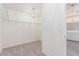 Walk-in closet features carpeted flooring and shelving with chandelier lighting at 9339 Bondeno St, Las Vegas, NV 89123