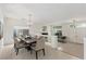 Elegant dining room with modern chandelier and a view of the living area and front door at 9339 Bondeno St, Las Vegas, NV 89123