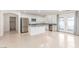 Bright, open kitchen with stainless steel appliances, island, and backyard access at 9339 Bondeno St, Las Vegas, NV 89123