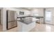 Modern kitchen with stainless steel appliances, white cabinets, and backyard view at 9339 Bondeno St, Las Vegas, NV 89123