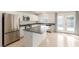 Modern kitchen with stainless steel appliances, center island, and backyard access at 9339 Bondeno St, Las Vegas, NV 89123
