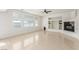 Spacious living room with fireplace, built-in shelves, and large windows at 9339 Bondeno St, Las Vegas, NV 89123
