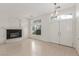 Bright living room featuring a cozy fireplace, large windows, and elegant flooring at 9339 Bondeno St, Las Vegas, NV 89123