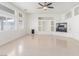 Bright living room with modern fireplace, ceiling fan, and abundant natural light at 9339 Bondeno St, Las Vegas, NV 89123