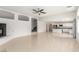 Open-concept living room with stairs, fireplace, and view of the kitchen at 9339 Bondeno St, Las Vegas, NV 89123