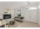 Bright living room featuring a fireplace, neutral decor, and large windows providing ample natural light at 9339 Bondeno St, Las Vegas, NV 89123
