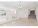 Bright, airy living room with stairs to the second floor, featuring sleek flooring and recessed lighting at 9339 Bondeno St, Las Vegas, NV 89123