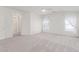 Bright primary bedroom boasts neutral carpet, ceiling fan, and ensuite bathroom entrance at 9339 Bondeno St, Las Vegas, NV 89123