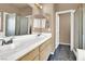 Bathroom featuring dual sinks and vanities, and glass shower doors, provides ample space at 1001 Padre Island St, Las Vegas, NV 89128