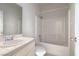 Clean bathroom featuring a tub with tile surround and vanity with sink at 1001 Padre Island St, Las Vegas, NV 89128