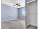 Comfortable bedroom with ceiling fan, large window, and closet for storage at 1001 Padre Island St, Las Vegas, NV 89128