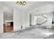 An open-concept living room features white walls and a view of the staircase at 1001 Padre Island St, Las Vegas, NV 89128