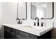 Bathroom vanity with dual sinks, black hardware, and a white countertop at 1069 Silver Bullet Ct, Henderson, NV 89011