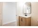 Bathroom featuring a wood vanity, black hardware, and an arched mirror at 1069 Silver Bullet Ct, Henderson, NV 89011