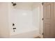 Clean white tiled bathtub and shower with black fixtures at 1069 Silver Bullet Ct, Henderson, NV 89011