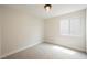 Neutral bedroom with a flush light fixture, large window, and neutral carpet at 1069 Silver Bullet Ct, Henderson, NV 89011