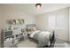 Cozy bedroom featuring a metal bed frame, stylish decor, and ample natural light from the window at 1069 Silver Bullet Ct, Henderson, NV 89011