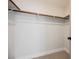 Walk-in closet features shelving and a wooden hanging bar at 1069 Silver Bullet Ct, Henderson, NV 89011