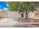 Charming single story home with an attached two car garage and mature shade tree in front yard at 1069 Silver Bullet Ct, Henderson, NV 89011