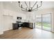 Open kitchen featuring stainless appliances, quartz counters, and a sliding door to the backyard at 1069 Silver Bullet Ct, Henderson, NV 89011