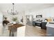 Open concept kitchen features stainless appliances, and an island with bar seating and modern lighting at 1069 Silver Bullet Ct, Henderson, NV 89011