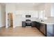 Open kitchen boasts stainless appliances, two-tone cabinets, and modern design elements at 1069 Silver Bullet Ct, Henderson, NV 89011