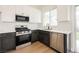 Well-lit kitchen featuring stainless steel appliances, two-tone cabinets, and quartz countertops at 1069 Silver Bullet Ct, Henderson, NV 89011