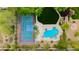 Aerial view of a backyard featuring a basketball court, lush landscaping, pool, and spa at 10726 Hawes End Ct, Las Vegas, NV 89183