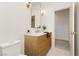 Elegant bathroom with a wood vanity, white countertop, gold fixtures and bright lighting at 10726 Hawes End Ct, Las Vegas, NV 89183